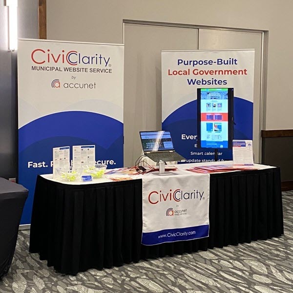 CivicClarity display booth with technology and banners